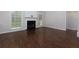 Bright living room with a fireplace, large windows, and hardwood floors at 306 Burdock Trce, Woodstock, GA 30188