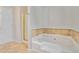 Bathroom featuring a soaking tub with marble accent and glass enclosed shower at 4400 Old Allgood Cir, Stone Mountain, GA 30083