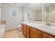 Bathroom featuring dual sinks, tile floor, and combination shower and tub at 4400 Old Allgood Cir, Stone Mountain, GA 30083