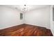 Bonus room featuring hardwood floors, large window, and modern chandelier at 4400 Old Allgood Cir, Stone Mountain, GA 30083