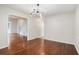 Dining room featuring hardwood floors, neutral walls, and an open view into the living room and staircase at 4400 Old Allgood Cir, Stone Mountain, GA 30083