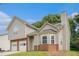 Charming two-story home with a brick-accented foundation, siding, arched window and well-manicured lawn at 4400 Old Allgood Cir, Stone Mountain, GA 30083