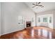 Living room featuring wood floors, neutral walls, a fireplace, and natural light through the large windows at 4400 Old Allgood Cir, Stone Mountain, GA 30083