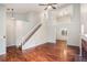 Bright living room featuring wood floors, a staircase to the left and an open view to a dining room at 4400 Old Allgood Cir, Stone Mountain, GA 30083