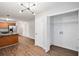 Open view from kitchen to a pantry/laundry room with vinyl floors, as well as view to other spaces at 4400 Old Allgood Cir, Stone Mountain, GA 30083