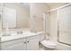 Bright bathroom featuring a tub-shower combo with sliding glass doors and a white vanity at 5509 Park S Pl, Atlanta, GA 30349