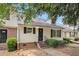 Charming townhome with a welcoming entrance, well-maintained landscaping, and black shutters at 5509 Park S Pl, Atlanta, GA 30349