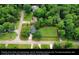 An aerial view of a home with a large grassy yard and mature trees at 1206 Red Fox Cir, Woodstock, GA 30188