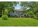 Expansive backyard with a patio, outdoor furniture, and well-manicured lawn at 1206 Red Fox Cir, Woodstock, GA 30188