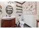 Bathroom features granite counters, dark wood vanity, shelves, and wainscoting at 1206 Red Fox Cir, Woodstock, GA 30188