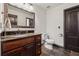Bathroom featuring granite counters, vessel sink, wainscotting, and dark trim at 1206 Red Fox Cir, Woodstock, GA 30188
