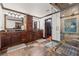 Luxurious bathroom featuring double vanities, stone tile, glass enclosed shower, and a walk-in closet at 1206 Red Fox Cir, Woodstock, GA 30188