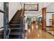 Grand entryway with a dark wood staircase and railing, opening to a spacious living area at 1206 Red Fox Cir, Woodstock, GA 30188