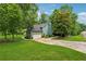 Charming home with a lush green lawn, two-car garage and a long driveway at 1206 Red Fox Cir, Woodstock, GA 30188