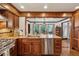 Well-equipped kitchen with granite countertops, stainless steel appliances, and wood cabinets at 1206 Red Fox Cir, Woodstock, GA 30188