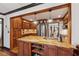 Kitchen island with a sink, wood cabinets, stone countertop, and hardwood floors at 1206 Red Fox Cir, Woodstock, GA 30188