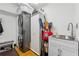 Clean laundry room equipped with a stackable washer/dryer and utility sink at 1206 Red Fox Cir, Woodstock, GA 30188