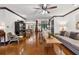 Spacious living room featuring a ceiling fan, hardwood floors, and ample natural light at 1206 Red Fox Cir, Woodstock, GA 30188