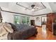 Spacious primary bedroom featuring tray ceilings, hardwood floors, and abundant natural light at 1206 Red Fox Cir, Woodstock, GA 30188