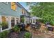 Charming backyard patio with stone pavers, outdoor seating, and lush landscaping at 1206 Red Fox Cir, Woodstock, GA 30188