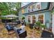 Inviting outdoor patio with stone flooring, comfortable seating, umbrella-covered table and a grill at 1206 Red Fox Cir, Woodstock, GA 30188