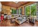 Bright sun room with comfortable seating and views of the lush outdoor greenery at 1206 Red Fox Cir, Woodstock, GA 30188