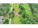 Expansive aerial view of a lovely country home with red roof nestled among lush trees and green pastures at 1365 Lower Creighton Rd, Cumming, GA 30028