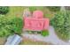 A birds eye view of a red-roofed country home featuring a deck and large lot at 1365 Lower Creighton Rd, Cumming, GA 30028