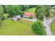 Charming home with a red roof, surrounded by lush greenery and a quaint barn at 1365 Lower Creighton Rd, Cumming, GA 30028