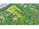 Aerial view of property with outline showing home, barn, and forested acreage with mature green trees at 1365 Lower Creighton Rd, Cumming, GA 30028