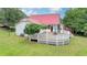 The home boasts a huge back deck overlooking the yard and a red metal roof at 1365 Lower Creighton Rd, Cumming, GA 30028