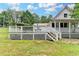 Large backyard features a white porch, stairs, and lots of green space at 1365 Lower Creighton Rd, Cumming, GA 30028