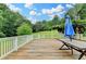 Wide angle view of the wood porch, umbrella, and greenery at 1365 Lower Creighton Rd, Cumming, GA 30028