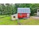 A country barn with a metal roof has easy access to nearby pastures at 1365 Lower Creighton Rd, Cumming, GA 30028