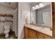 Well-lit bathroom with a granite-topped vanity and tile floors at 1365 Lower Creighton Rd, Cumming, GA 30028