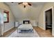 Bright bedroom featuring wood floors, ceiling fan, and a view into the ensuite bath at 1365 Lower Creighton Rd, Cumming, GA 30028