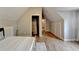Bright bedroom features wood floors and a view into the ensuite bath and hallway at 1365 Lower Creighton Rd, Cumming, GA 30028