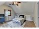 Bright bedroom features wood floors, a ceiling fan, and natural light from the window at 1365 Lower Creighton Rd, Cumming, GA 30028