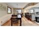 Dining room with hardwood floors, wood trim windows, and view of the kitchen at 1365 Lower Creighton Rd, Cumming, GA 30028