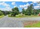 Gravel driveway leading to a beautiful property with a fenced yard and mature trees at 1365 Lower Creighton Rd, Cumming, GA 30028