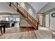 Inviting entryway with wooden staircase and views of the kitchen at 1365 Lower Creighton Rd, Cumming, GA 30028