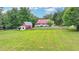A charming country home has a red barn, pastures, and a long porch at 1365 Lower Creighton Rd, Cumming, GA 30028