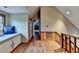 Hallway with wood floors, and a cushioned bench with storage underneath at 1365 Lower Creighton Rd, Cumming, GA 30028