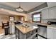 Open kitchen with butcher block countertops, stainless steel appliances, kitchen island, and white cabinets at 1365 Lower Creighton Rd, Cumming, GA 30028