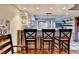 Kitchen bar seating area has room for three and corrugated metal trim at 1365 Lower Creighton Rd, Cumming, GA 30028