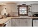 Charming kitchen features white cabinets, wood countertops and a view from a window above the sink at 1365 Lower Creighton Rd, Cumming, GA 30028