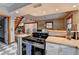 Bright kitchen featuring stainless steel appliances, wood countertops, tile flooring, and a wooden staircase at 1365 Lower Creighton Rd, Cumming, GA 30028