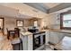 Bright kitchen featuring stainless steel appliances, butcher block countertops, white cabinetry, and barstool seating at 1365 Lower Creighton Rd, Cumming, GA 30028