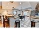 Bright kitchen featuring an island, butcher block counters, stainless appliances, white cabinetry, and black and white tile floors at 1365 Lower Creighton Rd, Cumming, GA 30028