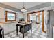 White kitchen boasts tile floors, stainless fridge, butcher block countertops, and an island with lots of counter space at 1365 Lower Creighton Rd, Cumming, GA 30028